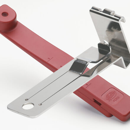 Malco's fiber cement overlap gauge laying on top of a red Malco facing Gauge